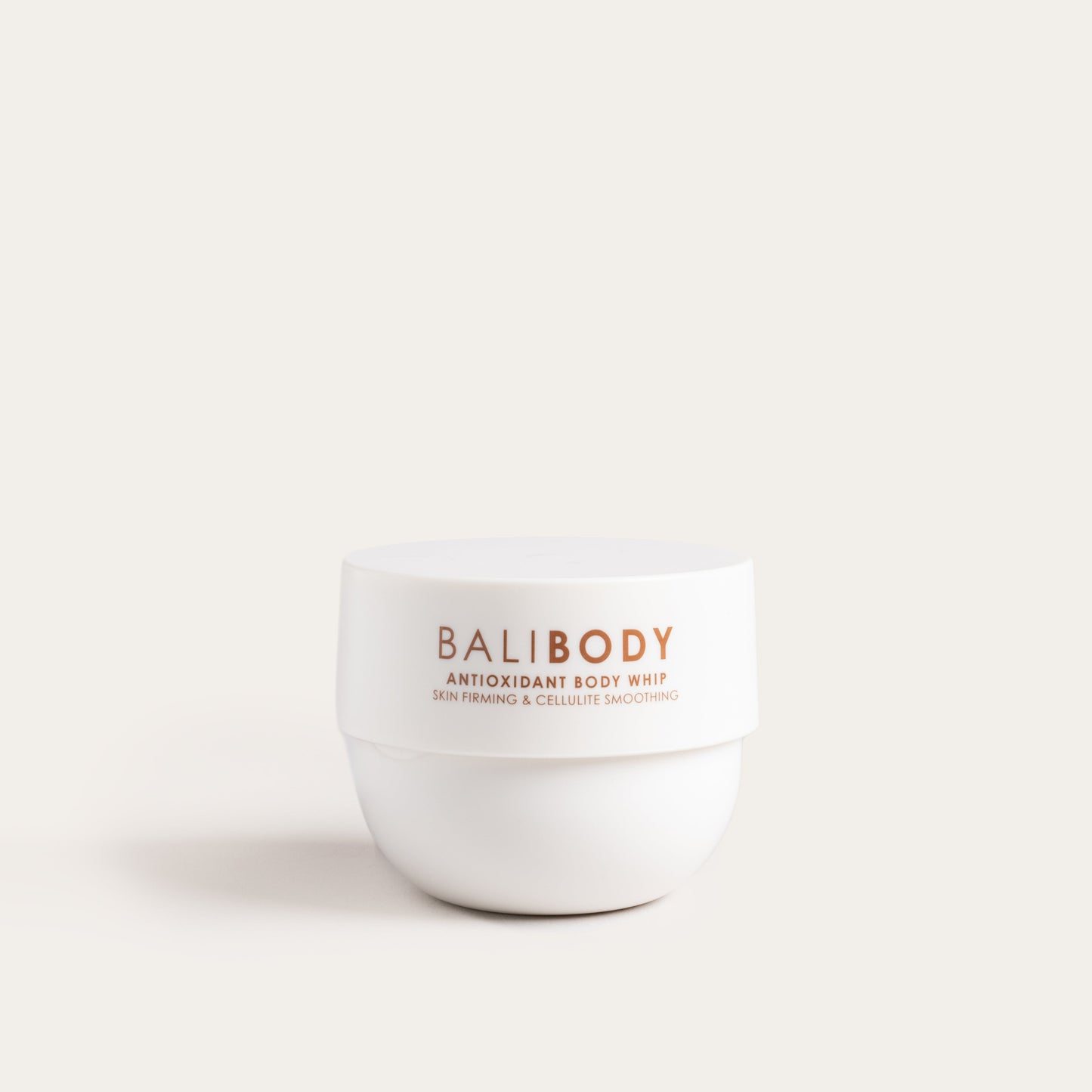A white jar of Bali Body Antioxidant Body Whip with a simple design and product information on the label.