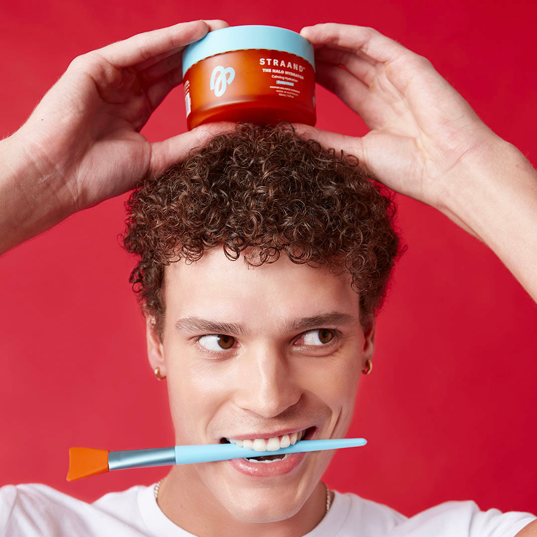 Man with curly hair showing the scalp mask on his head