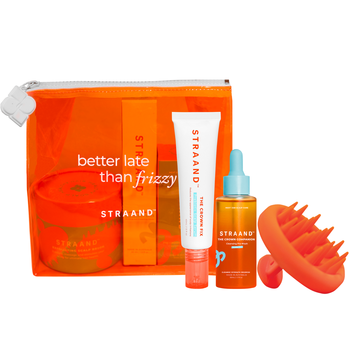 A collection of hair care products including a pre-wash scalp oil, a scalp serum, and a scalp brush, packaged in a bright orange translucent bag with 'better late than frizzy' text, and a small orange sun-shaped accessory.
