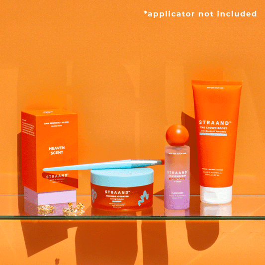 Orange background and a collection of hair products in the foreground with a slight animation showing movement of the products shadows