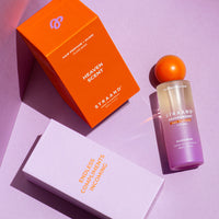 Hair perfume shown in it's purple and orange packaging