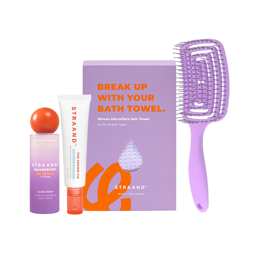 A collection of hair care products including a bottle of scalp serum, a hairbrush, a hair towel, and a box of hair perfume, all laid out on a white background with packaging that reads 'break up with your bath towel'.