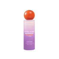 A bottle of HeavenScent Hair Perfume + Gloss with a purple label and a orange cap, indicating it is a hair care product.