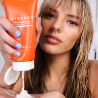 Woman with blonde straight hair using the Crown Boost conditioner in the shower