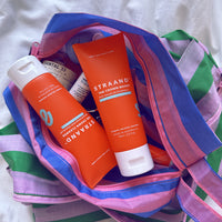 The Mini Duo Crown Cleanse Shampoo and Crown Boost Conditioner in a travel bag