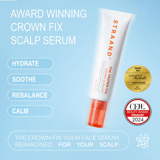 A bottle of 'The Crown Fix Scalp Serum' by STRAAND with a white body and red cap. It has text on the bottle and two seals indicating it as a Beauty Award Finalist and a Consumer Choice Award Winner.